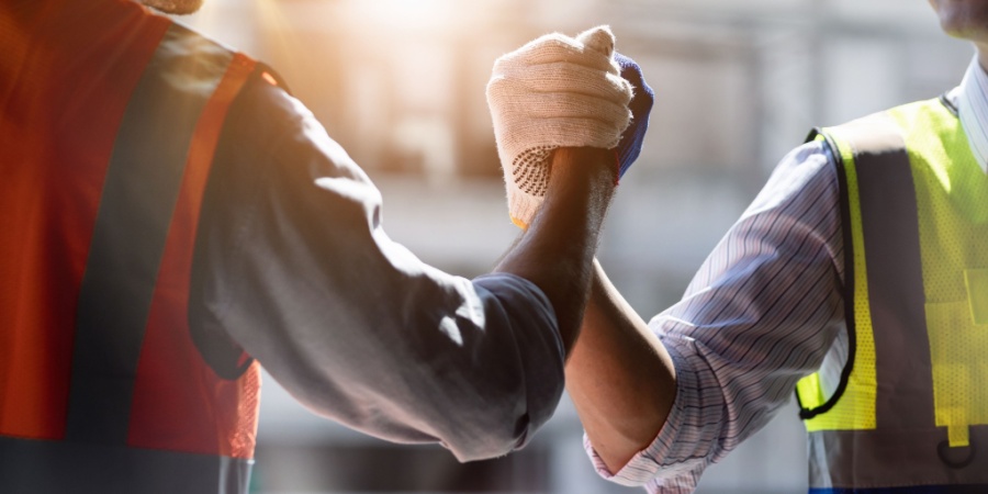 technicians shaking hands after successful work | Why the Right LMS Partner Is Critical to Business Success